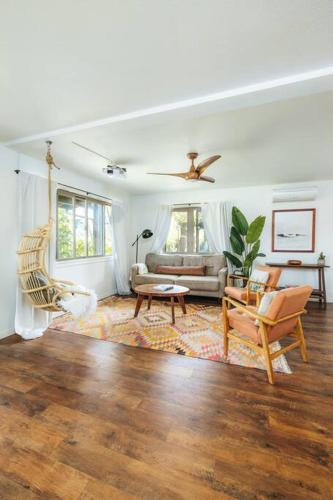 a living room with a couch and a table at The Kumu House in Kailua-Kona