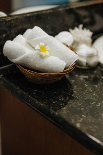 a basket of towels on top of a counter at The Kumu House in Kailua-Kona
