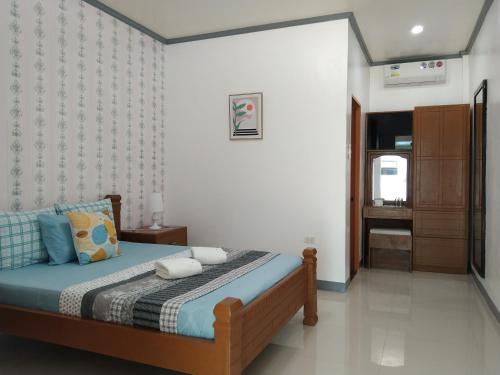 a bedroom with a bed with a blue comforter at ELEN INN - Malapascua Island Air-conditioned Room1 in Malapascua Island