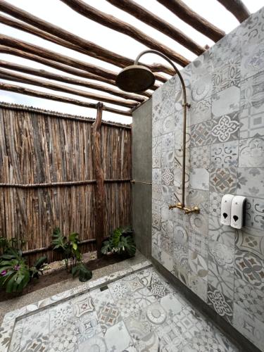 a bathroom with a wooden wall with rolls of toilet paper at GUAJIRA CASA DEL MAR in Ríohacha