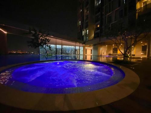 a blue fountain in the middle of a building at night at Kenwingston Skyloft Apartment Doorsteps to BRT Subang USJ in Subang Jaya