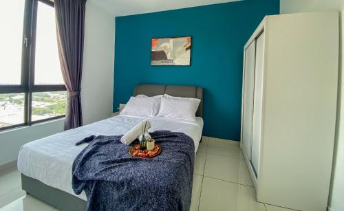 a bedroom with a bed with a blue wall at Kenwingston Skyloft Apartment Doorsteps to BRT Subang USJ in Subang Jaya