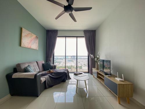a living room with a couch and a ceiling fan at Kenwingston Skyloft Apartment Doorsteps to BRT Subang USJ in Subang Jaya
