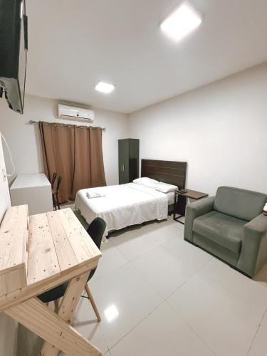 a room with a bed and a couch and a table at Departamento bonito y acogedor cerca de todo! in Asuncion