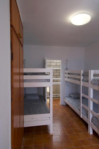 a room with three bunk beds in a room at Las Eras Nest Hostel in Las Eras