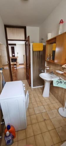 a bathroom with a sink and a toilet in it at Corte Toffoletti in Tarcento