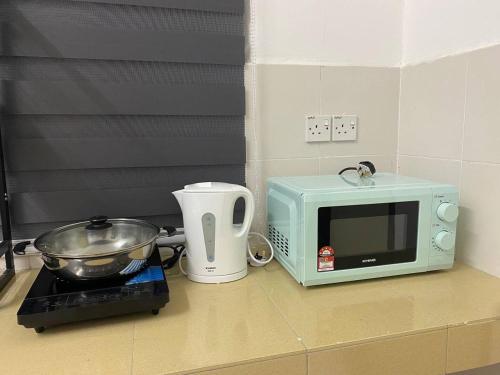 a kitchen counter with a microwave and a toaster at Spacious+Minimal+Manjung City Centre in Seri Manjung