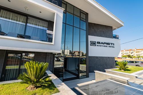 a building with a sign for a carmaker firm at Bareti Boutique Hotel in Kallithea Halkidikis