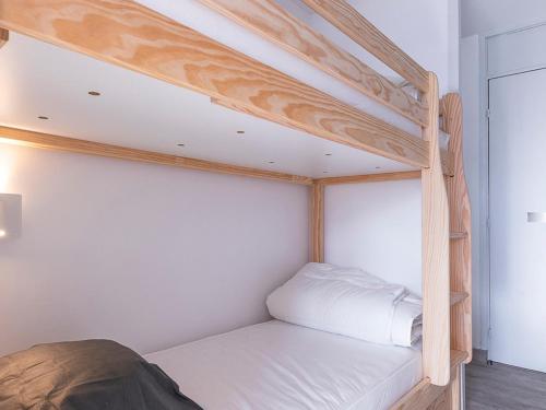 a bedroom with a bunk bed with white sheets at Studio Avoriaz, 1 pièce, 4 personnes - FR-1-314-216 in Morzine