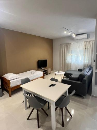 a living room with a couch a table and a bed at Twins Apartment in Përmet
