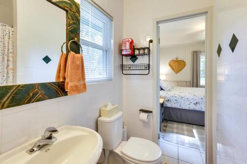 a small bathroom with a sink and a toilet at Riverfront Florida Escape with Grill and Fire Pit! in Tallahassee