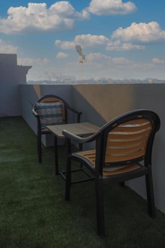 two chairs and a table on a balcony at شقق سوات للشقق المخدومة 4 in Al Khobar
