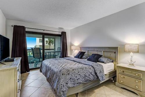 a bedroom with a bed and a balcony at Unobstructed Oceanfront Views in Gated Community-2 Pools-Surf & Racquet B123 in Fernandina Beach