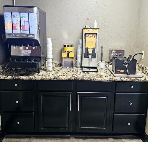 a counter top with a coffee maker and a coffee machine at Quality Inn & Suites Lexington South in Lexington
