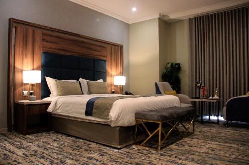 a large bedroom with a large bed and a chair at شقق سوات للشقق المخدومة 4 in Al Khobar
