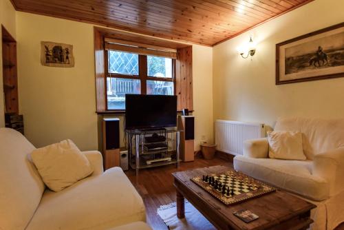 a living room with two couches and a television at Centre Lodge in Lerwick