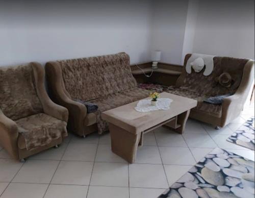 a living room with two couches and a coffee table at Penzión Stefanie in Vinné