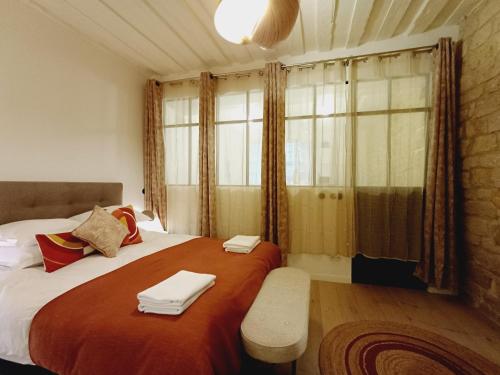 a bedroom with a large bed with towels on it at Happy Stay Paris - Suite Hotel de Ville le Marais in Paris