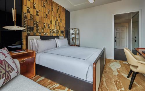 a bedroom with a bed and a desk and a chair at Viceroy Chicago in Chicago