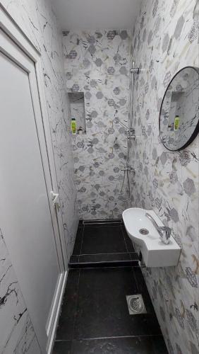 a bathroom with a sink and a mirror at Wonderland spa apartment in Niš
