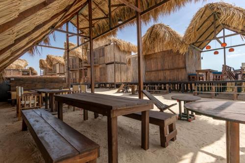 a group of tables and benches in a hut at CasaSolea in Mayapo