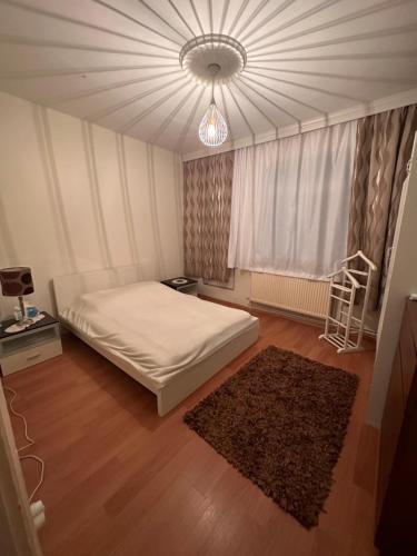 a bedroom with a bed and a chandelier at Bomontide metroya çok yakın şirin daire in Istanbul