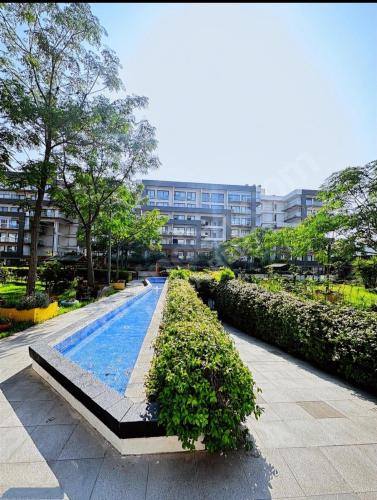 a large swimming pool in a city with a building at İzmir Bornova Residance in İzmir