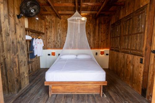 a bed in a wooden room with a glass ceiling at CasaSolea in Mayapo