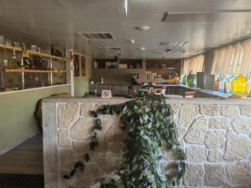 a bar in a kitchen with a stone wall at Route House 39 Motel in Jõgeva