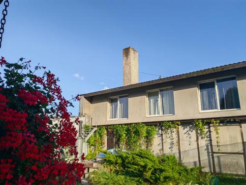 a building with a chimney on top of it at Route House 39 Motel in Jõgeva