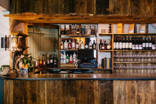 a bar with a lot of bottles of alcohol at Coorie Inn Restaurant and Rooms in Crieff