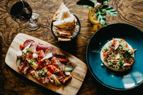 a table with a plate of food and a plate of bread at Coorie Inn Restaurant and Rooms in Crieff