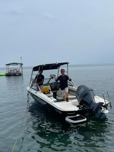 two people on a boat in the water at The Philip Ann Resort in Mabini