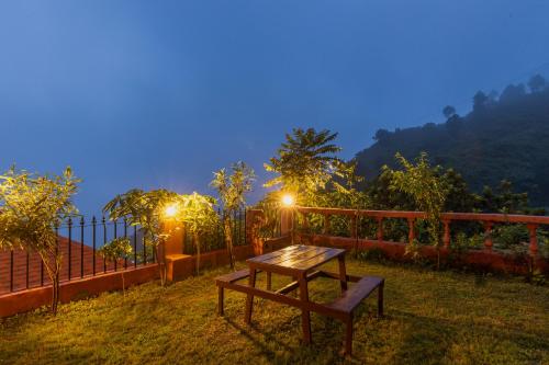 a wooden table and a bench in a yard at night at Villa by Mountain Homes- Lansdowne in Lansdowne