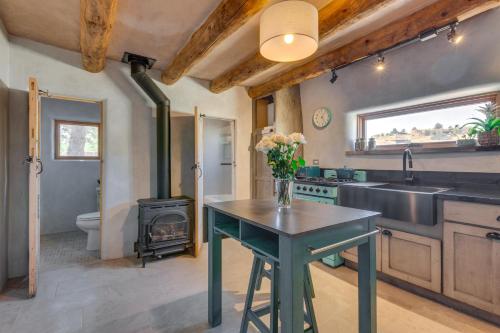 a kitchen with a sink and a stove at Beautiful Historic Adobe Home about 3 Mi to Taos Plaza in Taos