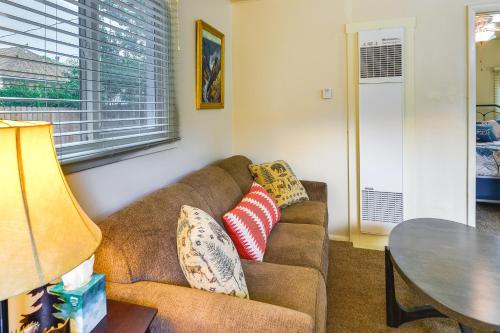 a living room with a couch and a table at Quaint Cody Cottage with Grill Walk to Downtown! in Cody