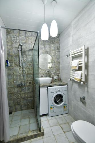 a bathroom with a washing machine and a sink at Perfect Place in Kutaisi