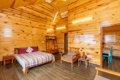 a bedroom in a log cabin with a bed and a chair at Villa by Mountain Homes- Lansdowne in Lansdowne
