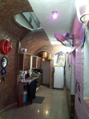 a kitchen with a brick wall and a white refrigerator at Gina Motel Dahab in Dahab
