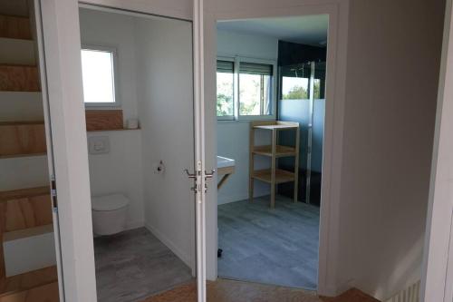 a bathroom with a toilet and a sink and a mirror at Maison bois Les Conches 6/8 Pers in Longeville-sur-Mer