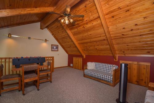 a living room with wooden ceilings and a ping pong table at Sunplace 07 in McHenry