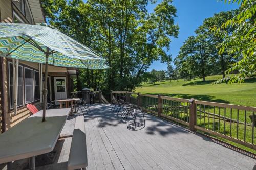 a patio with a table and chairs and an umbrella at Sunkissed Lodge in McHenry