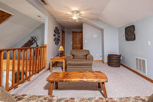 a living room with a chair and a table at Sunkissed Lodge in McHenry