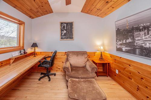 a living room with a chair and a desk at Sunkissed Lodge in McHenry