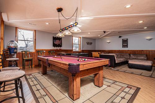 a living room with a pool table in it at Sunkissed Lodge in McHenry