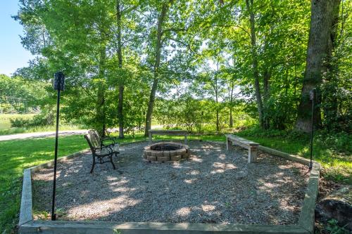 a park with a bench and a fire pit at Sunkissed Lodge in McHenry