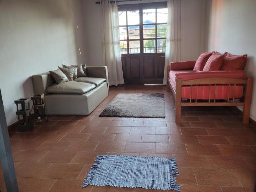 a living room with two couches and a rug at Dpto Céntrico con Balcón Dpto 1 in Puerto Iguazú