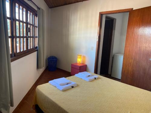 a bedroom with two beds with towels on them at Dpto Céntrico con Balcón Dpto 1 in Puerto Iguazú