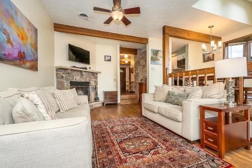 a living room with a white couch and a fireplace at Ski Harbor 19 in McHenry