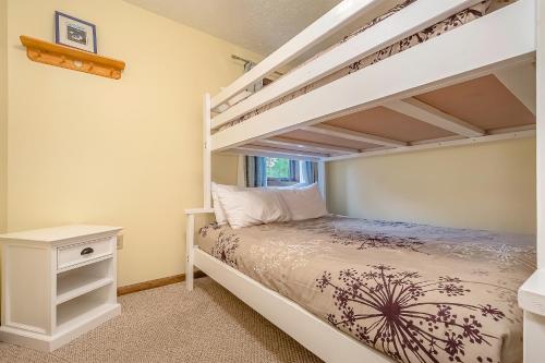 a bedroom with two bunk beds and a desk at Ski Harbor 19 in McHenry